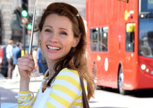 Load image into Gallery viewer, Bespoke Food Tour with Jennifer Earle in London. Smiling Jen in front of a red London bus.
